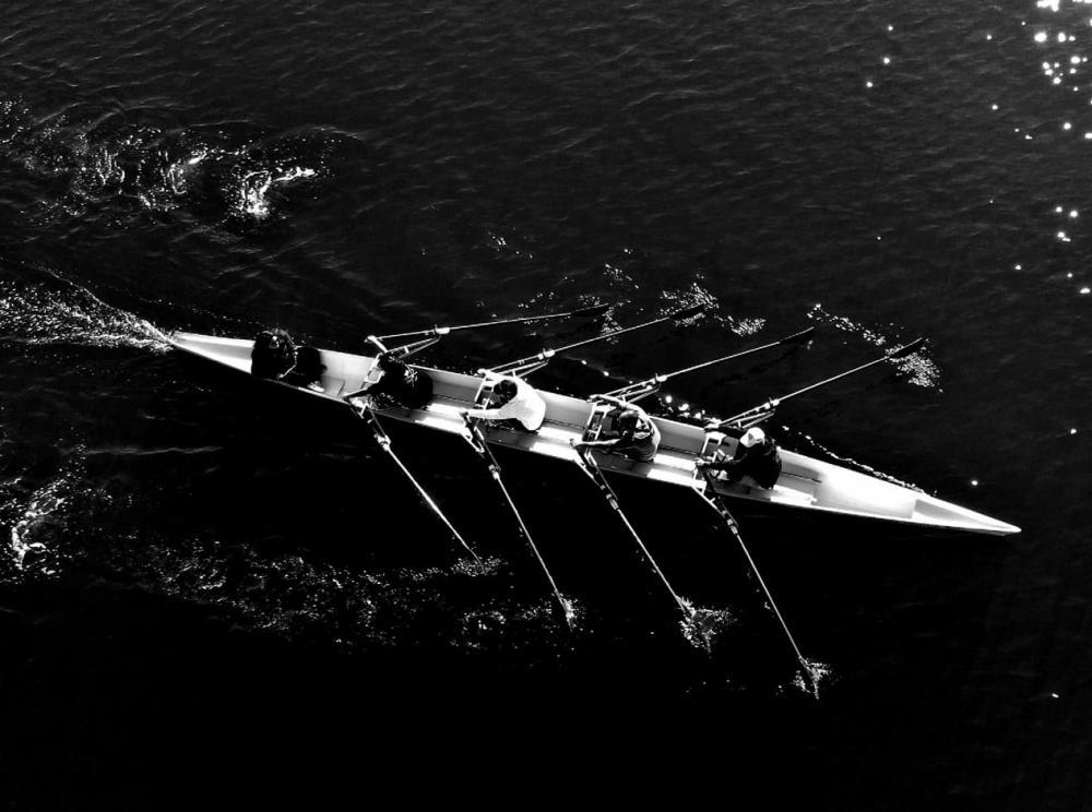 rowers on lake black and white